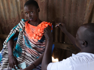Nakia John, que vive no acampamento de deslocados internos de Bentiu, está sendo vacinada contra a hepatite E em resposta a um surto, a primeira vez no mundo. Unity State, Sudão do Sul, abril de 2022.