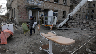 Funcionários do Serviço Estadual de Emergência da Ucrânia e equipe de saúde retiram equipamentos médicos de uma maternidade destruída por um ataque com mísseis russos na cidade de Selydove, na região de Donetsk. Ucrânia, fevereiro de 2024. ©Anatolii STEPANOV/AFP