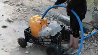 Palestinian child is collecting water in Beit Lahia city, north of Gaza strip, Palestine.