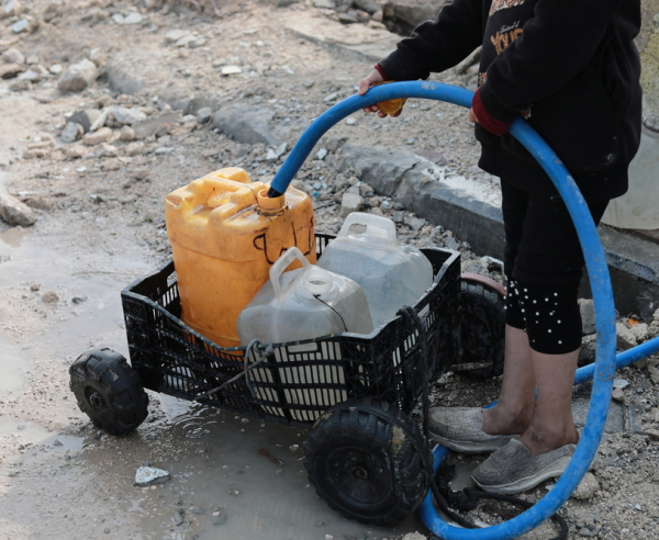 Palestinian child is collecting water in Beit Lahia city, north of Gaza strip, Palestine.