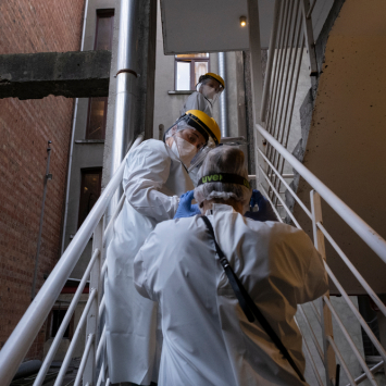 Medical staff talks with a patient and walking during the medical round in the isolation area of the medical center.