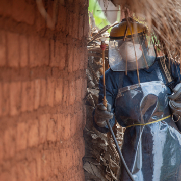 A sprayer is treating a house against mosquitoes during the 2019 indoor residual spraying campaign in Kinyinya health district.